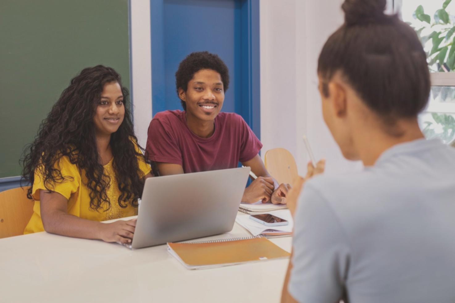 Person reviewing financial documents with laptop and coffee